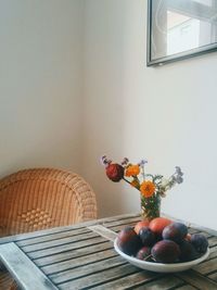 Fruits in vase on table at home