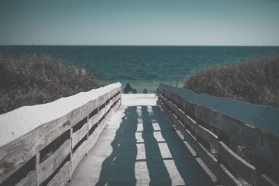 Pier over sea against clear sky