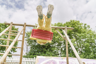 Girl swinging on swing at playground