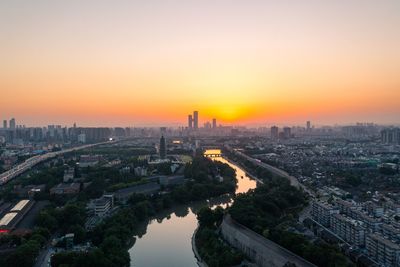 High angle view of city buildings during sunset