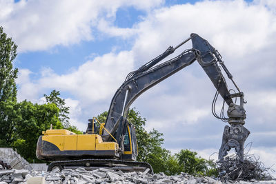 Crane at construction site against sky
