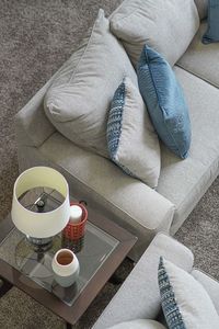 High angle view of coffee cup on sofa