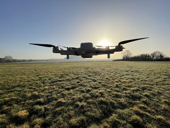 Low angle view of airplane flying on field against sky