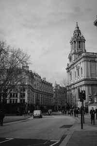 View of city street and buildings against sky