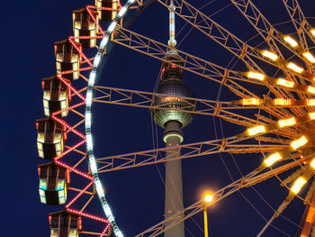 Low angle view of illuminated ferris wheel at night