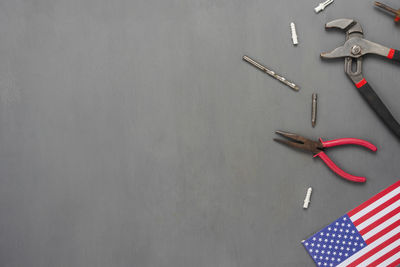 High angle view of tools and american flag on gray background