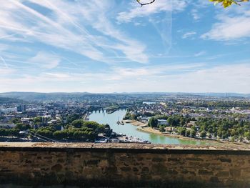 High angle view of river amidst buildings in city against sky