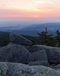 Scenic view of rocks against sky during sunset