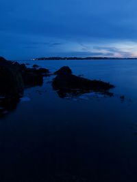 Scenic view of sea against sky at dusk