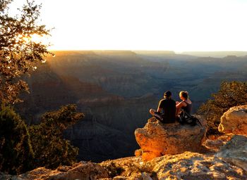 Rear view of man and woman on rock at canyonlands national park