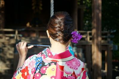 Woman holding pink flower