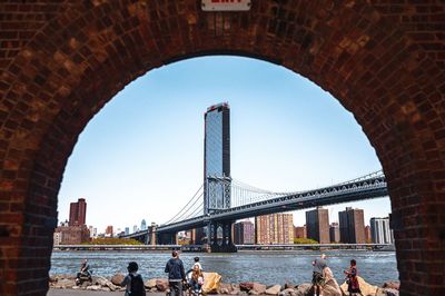 View of bridge and city buildings against clear sky