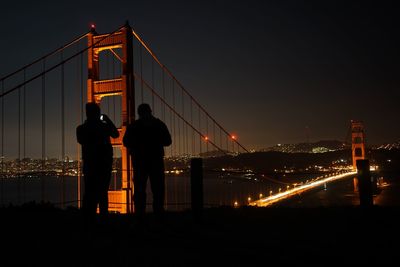 Illuminated bridge at night