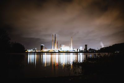 Smoke emitting from factory against sky at night