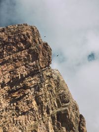 Low angle view of rock formation against sky