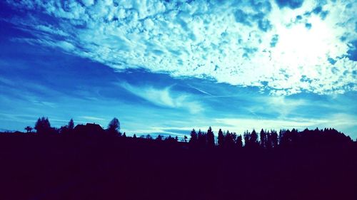 Silhouette of landscape against cloudy sky