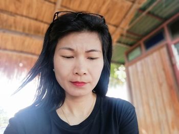 Woman looking down in hut