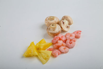 High angle view of chopped fruits against white background