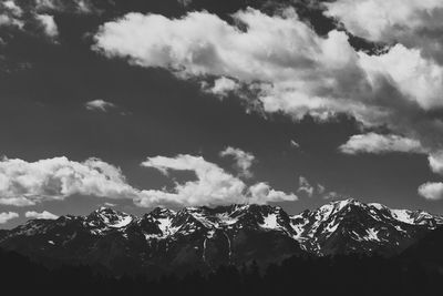 Low angle view of snowcapped mountains against sky