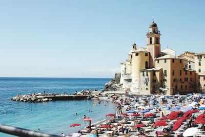 View of sea and buildings against sky