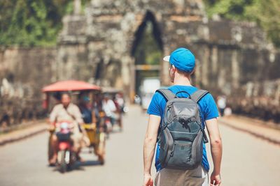 Rear view of backpacker on road