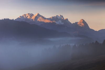 Scenic view of mountains against sky at sunset