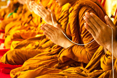 Close-up of woman holding yellow petals