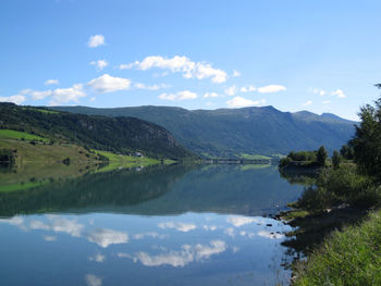 Scenic view of lake and mountains against sky