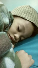 Close-up of baby sleeping on bed