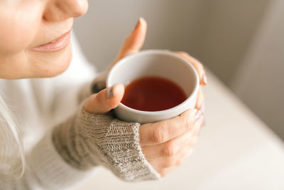 Close-up of woman holding coffee cup