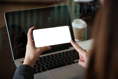 Midsection of woman using laptop