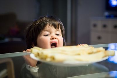 Close-up of cute girl eating food