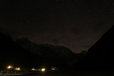 Scenic view of silhouette mountain against sky at night