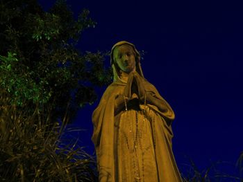 Low angle view of statue against sky at night