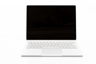 Close-up of laptop on table against white background