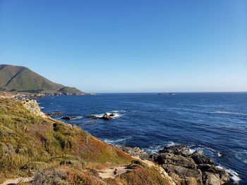 Scenic view of sea against clear blue sky