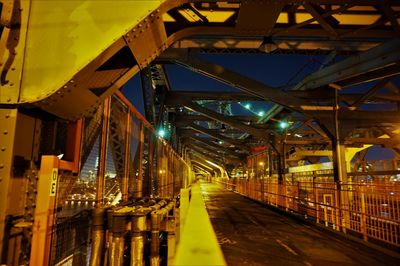 Illuminated bridge in city at night