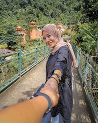 Low section of woman standing on bridge