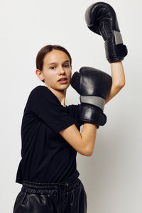 Portrait of teenager girl wearing boxing gloves