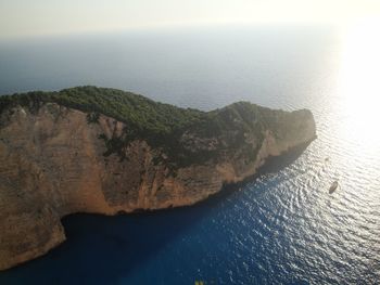High angle view of rocks by sea against sky