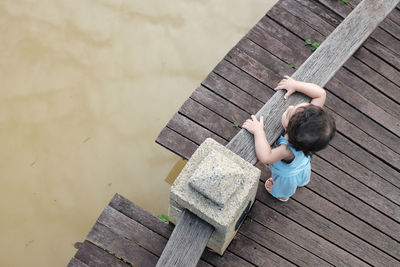 High angle view of child on jetty