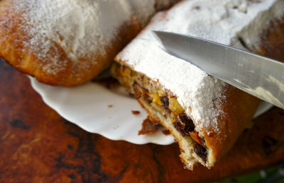 Close-up of knife slicing strudel