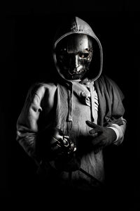 Portrait of young man holding black background