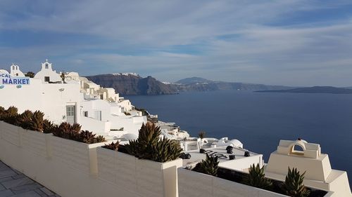 High angle view of buildings by sea against sky