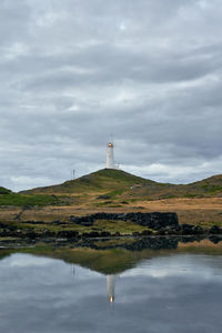 Picturesque scenery of lonely beacon under cloudy sky