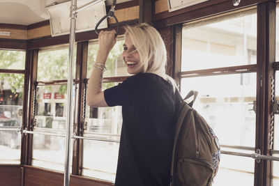 Young woman standing in bus