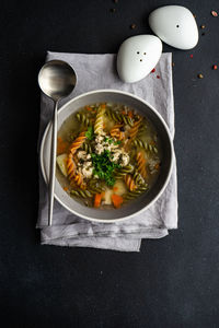 Directly above shot of pasta soup in bowl on table