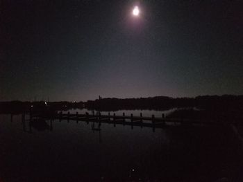 Scenic view of river against sky at night