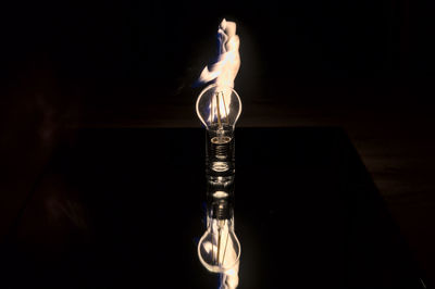 Close-up of illuminated lamp against black background