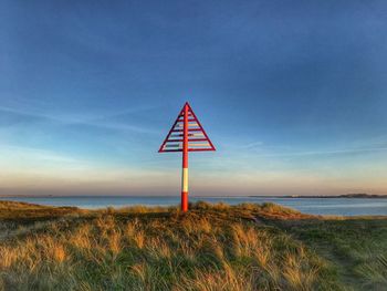 Lifeguard hut on beach against sky